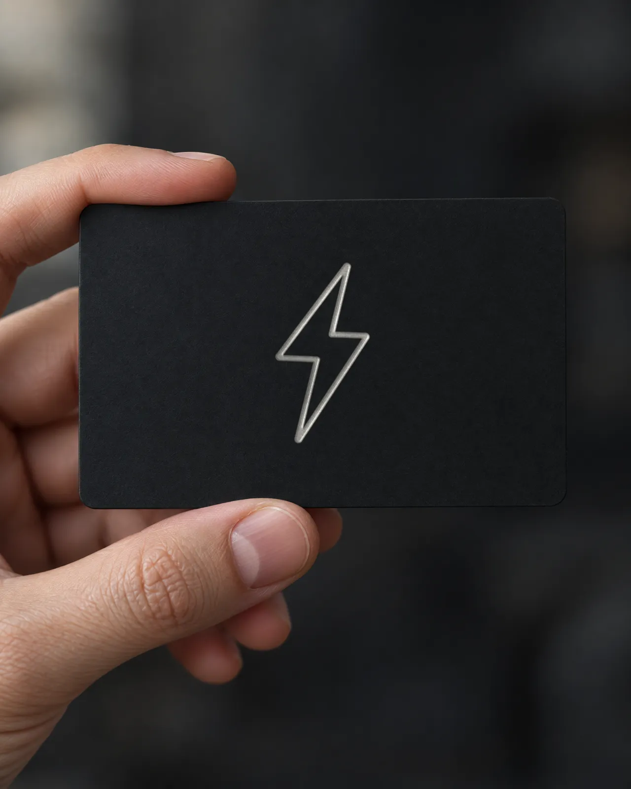A matte black ZapCard held in a hand